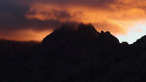 4K real time long shot of Sunset Clouds blowing in The Organ Mountains Stock Footage 229018648
