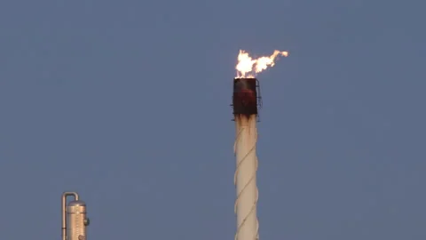 4K real time long shot of a flaming refinery stack on a winter day in Oklahoma Stock Footage 229744696