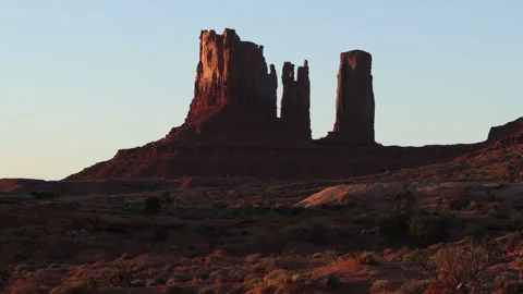 4K Real Time long shot of Sunrise sunlight on rock formations in Monument Valley Stock Footage 253345267