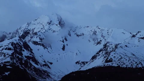 4K real time of a snowy, cloudy mountain at blue hour in Seward, Alaska Stock Footage 242945243