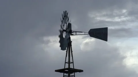 4K real time of a spinning windmill and rain clouds in the American west Stock Footage 166814665