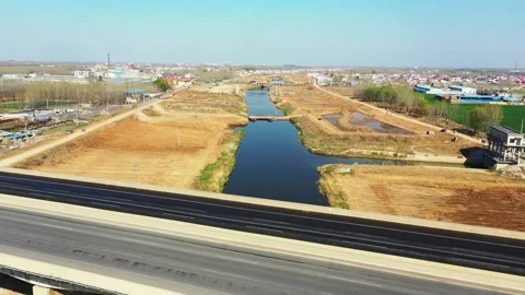 4K Real Time Traffic Flow on Xiaoqing River Grand Bridge and Levee Construction Stock Footage 319889757