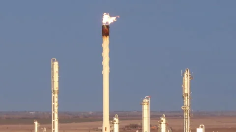 4K real time view of flames from a refinery tower on a winter day in Oklahoma Stock Footage 229744268
