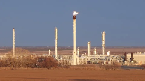 4K real time view of a refinery with flaming towers on a winter day in Oklahoma Stock Footage 229744748