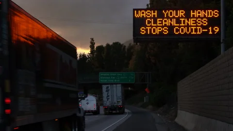 4K Real time wide shot of a COVID-19 wash hands highway sign in Los Angeles Stock Footage 130414161