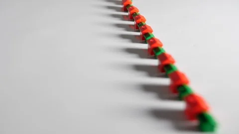 4K Red and green plastic houses in a long row white background surface Stock Footage 90803791