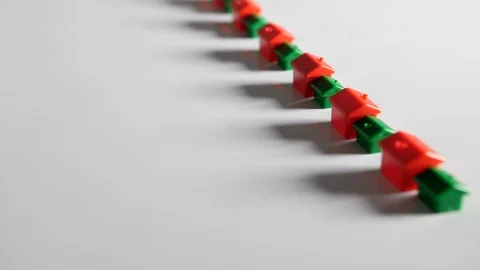 4K Red and green plastic houses in straight line a long row white background  Stock Footage 90807410
