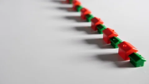 4K Red and green plastic houses in straight line a long row white background  Stock Footage 90807803