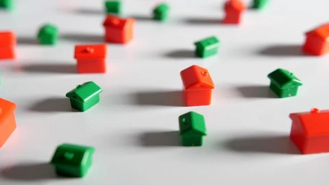 4K red and green plastic houses falling on a white background surface Stock Footage 90823138