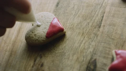 4K Red Icing Added to a Santa Hat Gingerbread Cookie Stock Footage 342113612