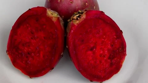 4K red prickly pear with one whole fruit and one cut open half 動画素材 348118757