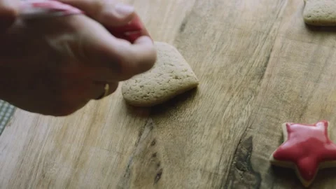 4K Red Star Gingerbread Cookie Displayed on Rustic Wood Stock Footage 342113547