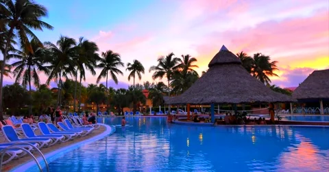 4K Reflection of Purple Setting Sun over Tropical Pool Stock Footage 46603176