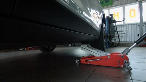 4K Removing of axle jack after the change the wheel Stock-Footage 96540534