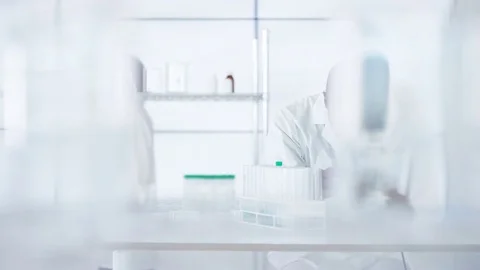 4K Research scientist working in laboratory, looking at sample under microscope. Stock Footage 73292891
