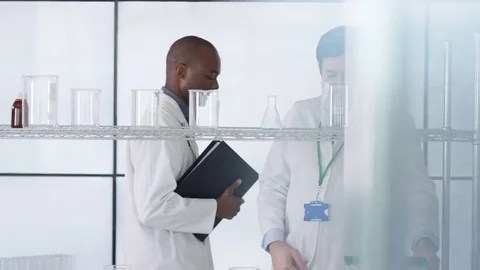 4K Research scientist working in laboratory, looking at sample under microscope. Stock Footage 73306574