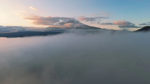 4K Reveal through clouds Aerial Mt Fuji Volcano Japan Stock Footage 300056737