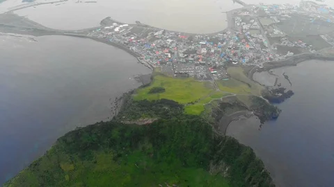 4K Reverse aerial drone shot of sunrise peak volcanic cone while camera pans up Stock Footage 91092553