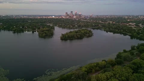 4K Reverse Aerial View of Minneapolis Skyline Behind Lake Of The Isles Islands Stock Footage 220469838