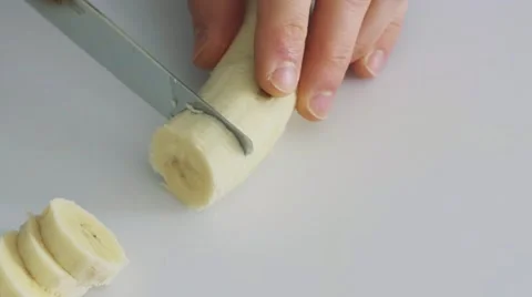 4K - REVERSE banana slicing Stock Footage 61545516