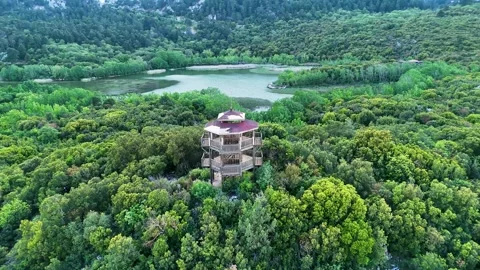 4K reverse  drone orbit of observation tower at Kovada Lake in forest landscape Stock Footage 336449850