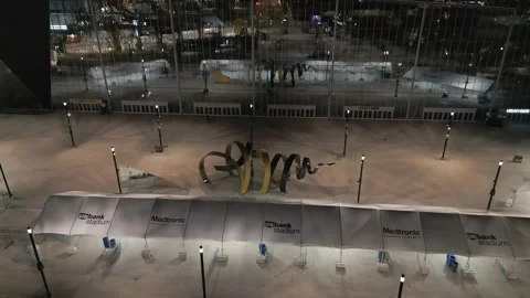 4K Reverse Drone Shot Of Horn Sculpture At Stadium Reflecting Skyline At Night Stock Footage 225649707