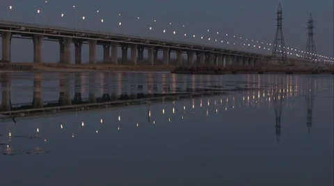 4K road bridge with lights reflected in the water at sunset Video stock 45814300