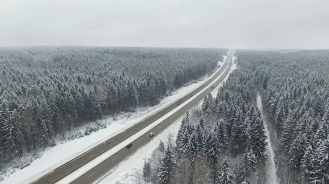 4K. Road in the winter forest with driving cars. Aerial panoramic view. Video stock 58949554