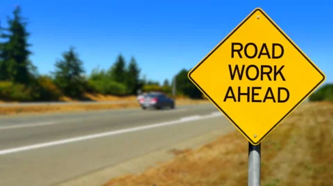 4K Road Work Ahead, Yellow Diamond Sign, Seamless Looping Stock Footage 68004221