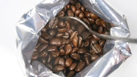 4k  Roasted coffee beans in foil bag, taking with spoon to make hot drink clo Stock Footage 90103183