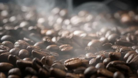 4K Roasted coffee beans with gentle steam and smoke rising. Close up macro .. Stock Footage 331594245