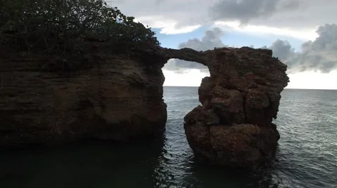 4K Rock Arch Fly Through Over Water Stock Footage 63473643