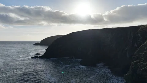 4K Rocky Sea Cliffs with Waves and Low Sun Vídeos de archivo 333707910