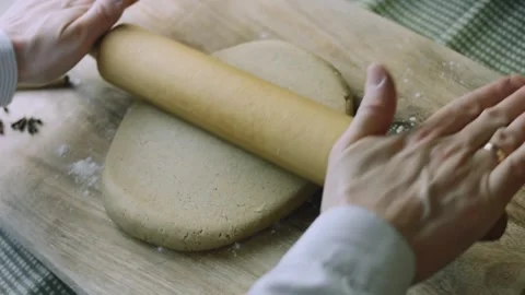 4K Rolling Pin Flattening Gingerbread Dough on a Floured Board Stock Footage 342113386