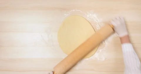4K - Rolling pin rolls out the Dough. Top view Video stock 136413394