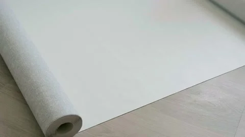 4K. Rolls of wallpaper and roller. Preparation for repair in the apartment. Video stock 161965217