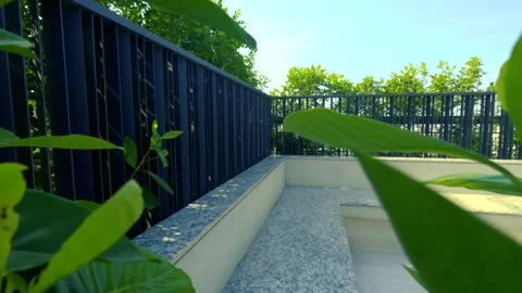 4K Rooftop Sitting Area with Plants, Furniture, and Urban City View Stock Footage 315638105
