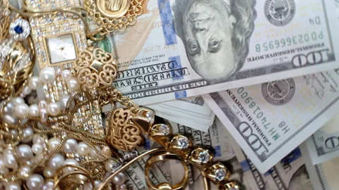 4k rotating footage top view of many one hundred dollar bills and gold jewelry Stock Footage 242237029