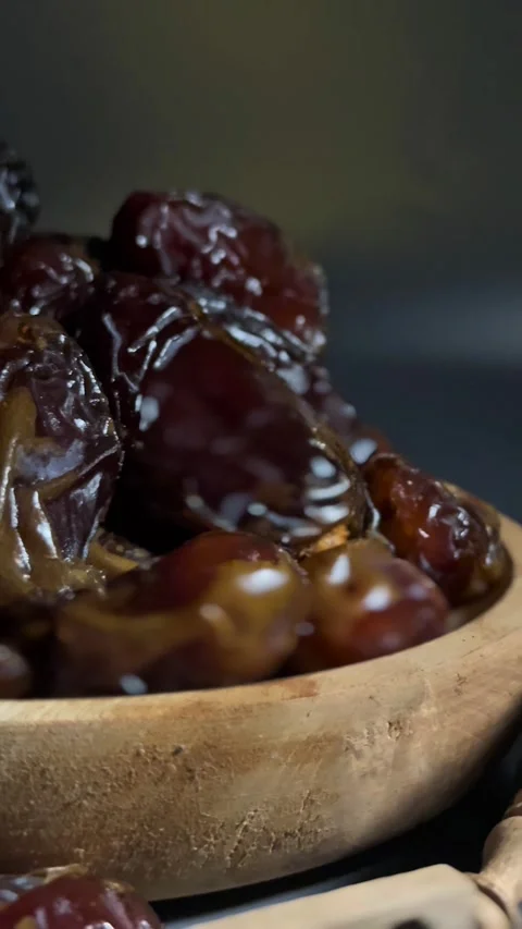 4K Rotating Shot of Dried Dates Showcasing Texture on Dark Background Stock Footage 328136876