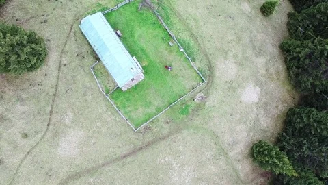 4K rotating upward aerial drone flight over house in green field surrounded by 스톡 동영상 80430163