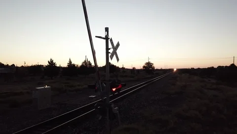 4K RR Xing as freight train approaches Stock-Footage 101076900