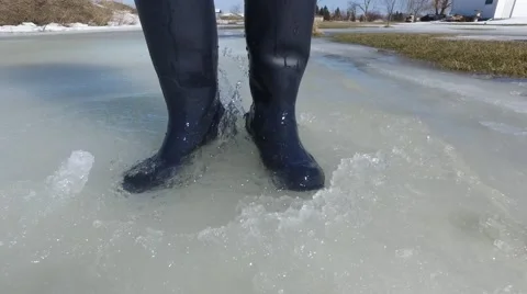 4k rubber boots dancing and splashing in slush Stock Footage 61374078