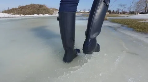 4k rubber boots splash happily in slush Stock Footage 61374290
