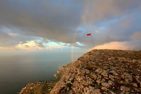 4K. Russian flag on the top of a mountain on the background of the sea Stock Footage 40181001