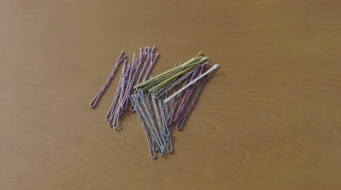 4K S-log 2 caucasian hand takes bobby pin/hair-clip from pile and places back Stock Footage 56528651