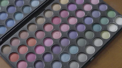 4K S-log 2 fake eyelashes placed on multicoloured eyeshadow pallet Stock Footage 56526415