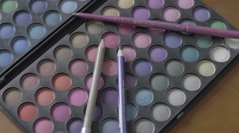 4K S-log 2 liner pencils lie on eye make up pallet and get picked up Stock Footage 56526804