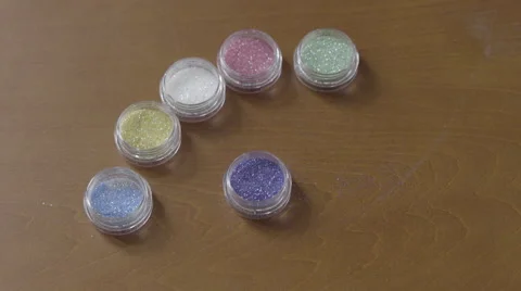 4K S-log 2 make up brush takes multicolored glitter out of tiny pots Stock Footage 56528197