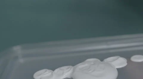 4K S-log 2 paintbrush dips in white paint and mixes it around Stock Footage 56725183