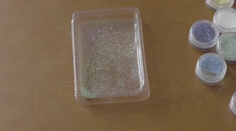 4K S-log 2 placing 6 little pots of glitter back in box Stock Footage 56528496